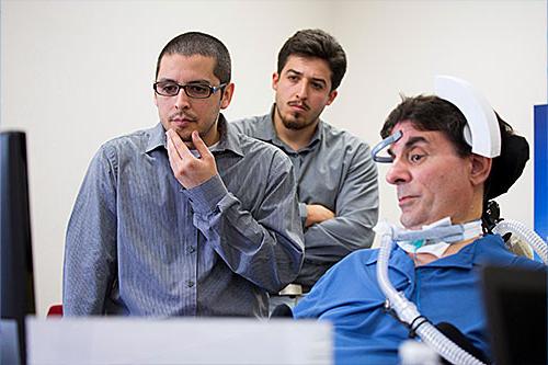 Students evaluating prototype headset with ALS patient
